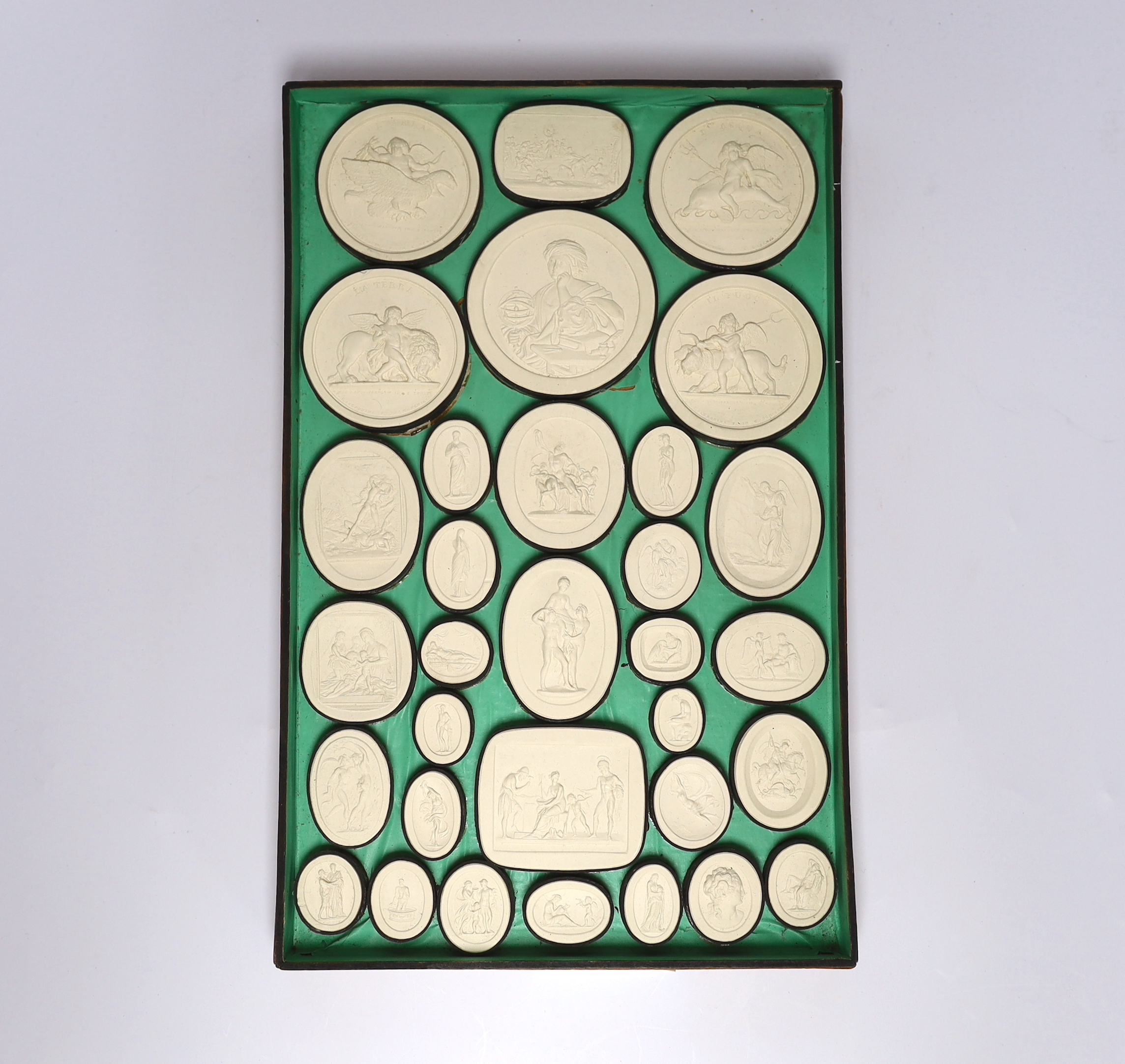 A cased set of thirty two Italian Grand Tour plaster roundels after intaglios of various subjects